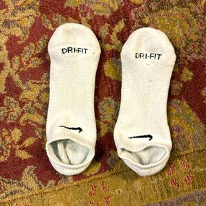 White Nike no show socks.